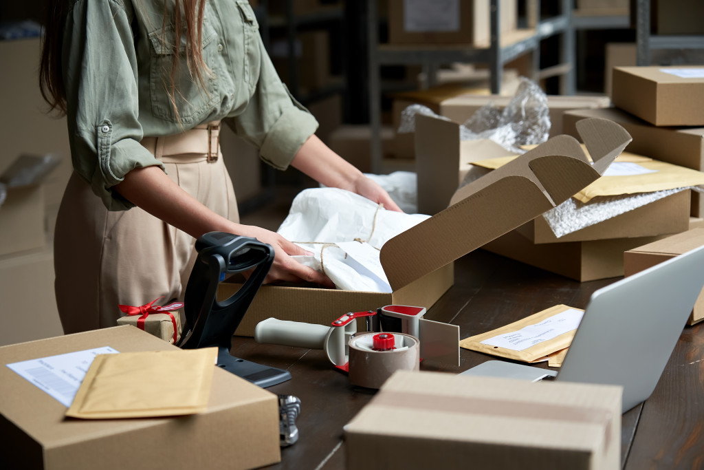 business owner using box to pack orders